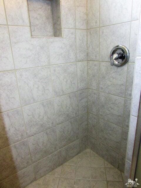 bathroom with a tile shower