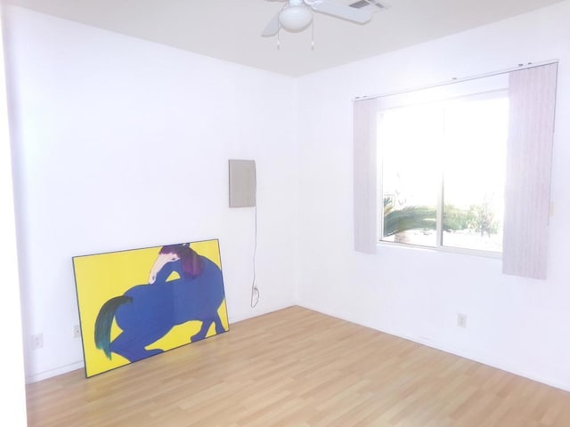 empty room featuring ceiling fan and hardwood / wood-style floors