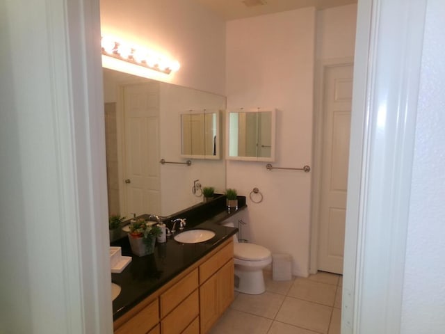 bathroom with tile patterned floors, vanity, and toilet