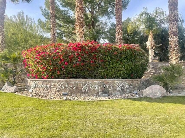 community / neighborhood sign with a lawn