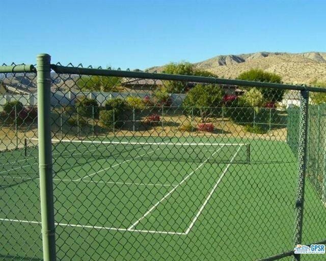 view of tennis court with a mountain view