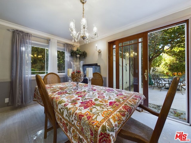 dining room featuring a notable chandelier, ornamental molding, and hardwood / wood-style floors