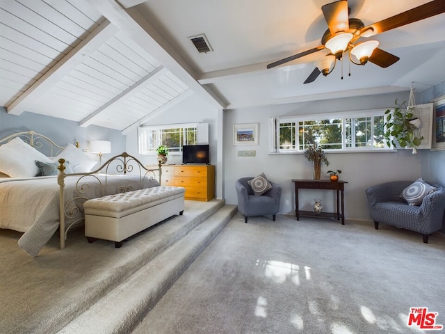 bedroom with lofted ceiling with beams, ceiling fan, and multiple windows