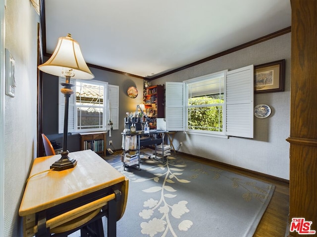 dining area featuring hardwood / wood-style flooring and crown molding