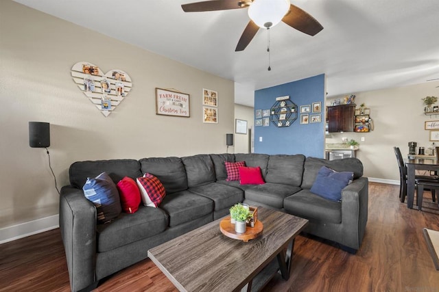 living room featuring ceiling fan and dark hardwood / wood-style flooring