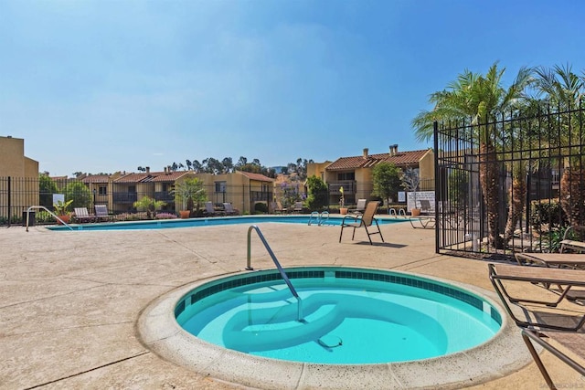 view of swimming pool featuring a community hot tub