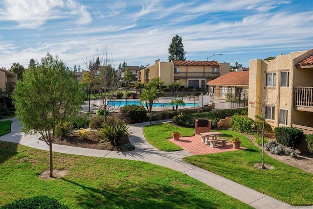 surrounding community featuring a yard and a swimming pool