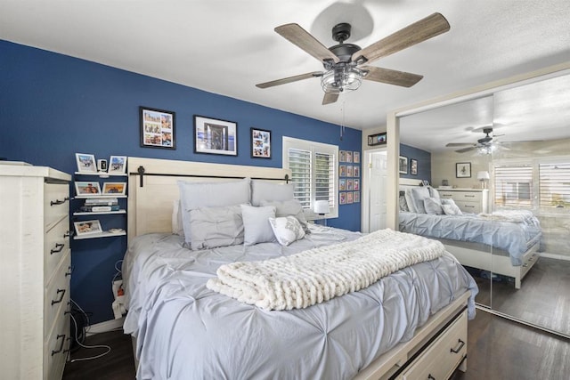 bedroom with ceiling fan and dark hardwood / wood-style floors