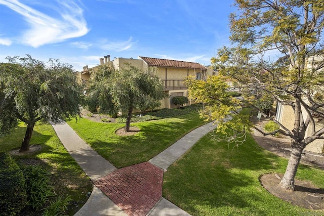 view of property's community with a lawn