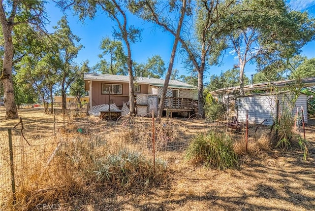 back of property featuring a wooden deck