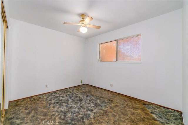 empty room featuring ceiling fan and carpet flooring