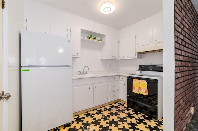 kitchen with white fridge, white cabinetry, range with electric cooktop, and sink