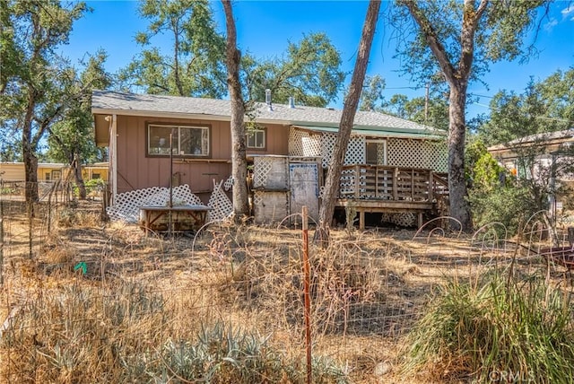 back of house with a deck