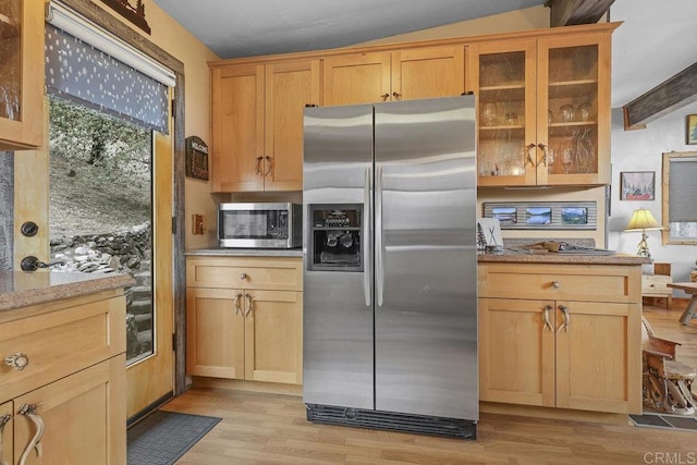 kitchen with light hardwood / wood-style floors, stainless steel appliances, and light stone counters