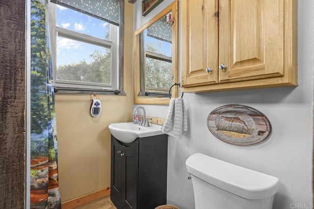 bathroom featuring toilet and vanity