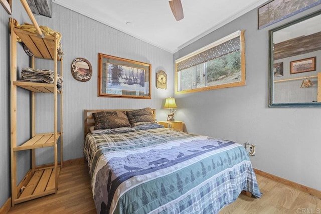 bedroom with ornamental molding, ceiling fan, and hardwood / wood-style floors