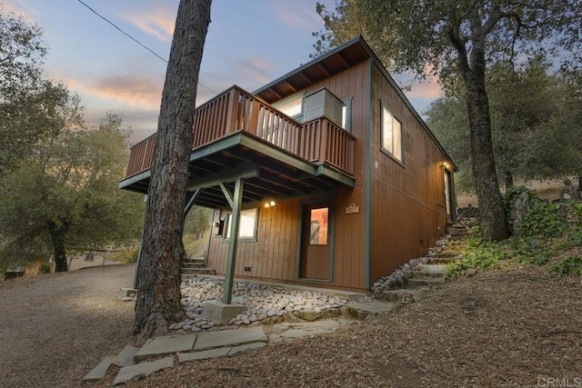 back house at dusk with a deck