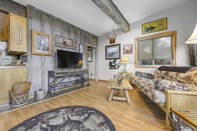 living room with light hardwood / wood-style floors and beamed ceiling