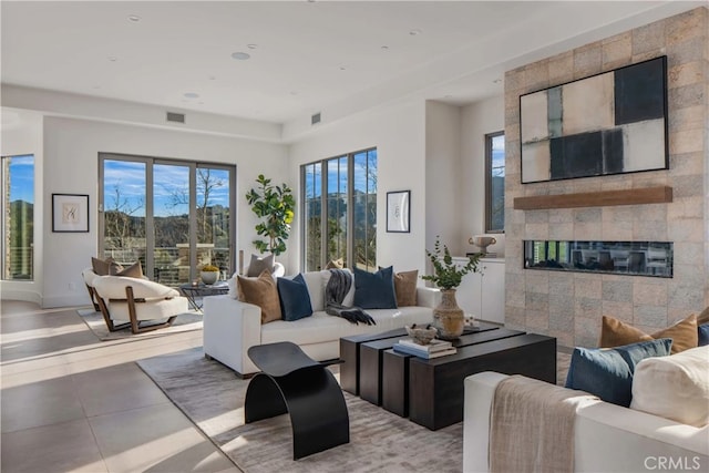 living room featuring a tiled fireplace