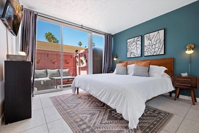 bedroom featuring expansive windows and access to exterior