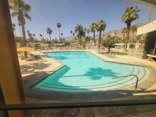 view of swimming pool featuring a mountain view and a patio