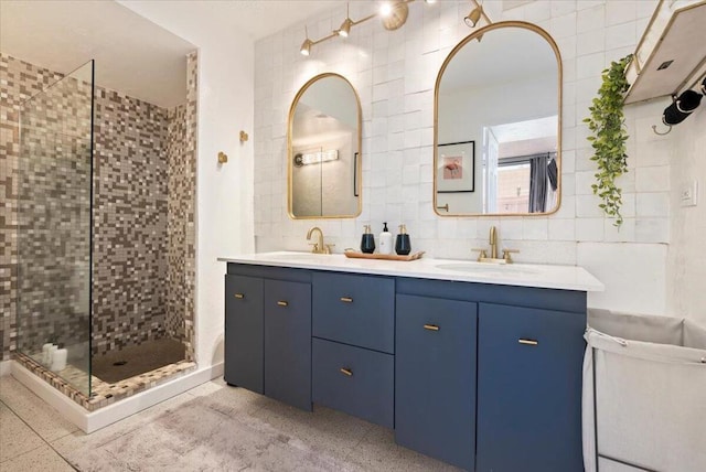 bathroom with an enclosed shower, vanity, and decorative backsplash