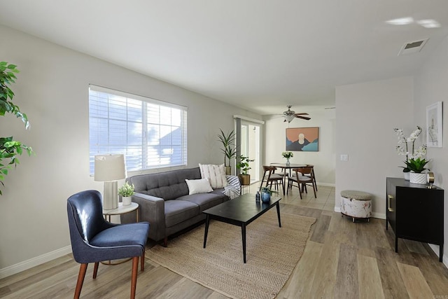 living room with ceiling fan and light hardwood / wood-style floors