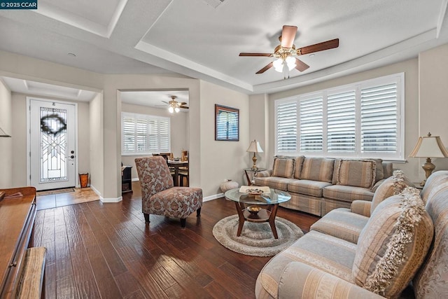 living room featuring ceiling fan, dark hardwood / wood-style flooring, and coffered ceiling