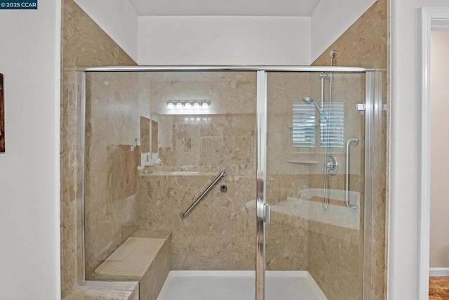 bathroom with a shower with door