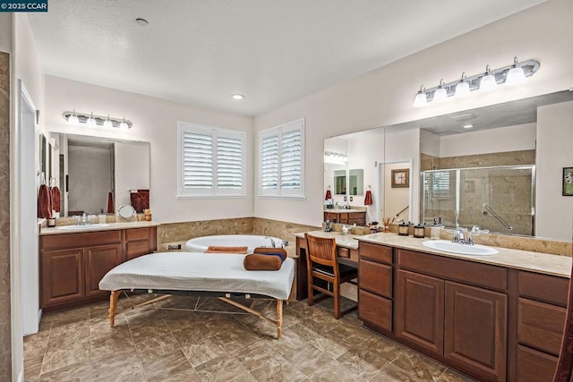 bathroom with a shower with shower door and vanity