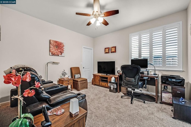 carpeted office space with ceiling fan