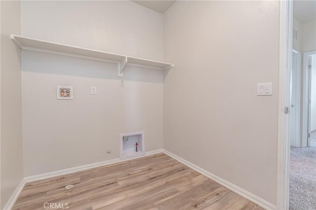 laundry room with gas dryer hookup, hookup for a washing machine, and light hardwood / wood-style flooring