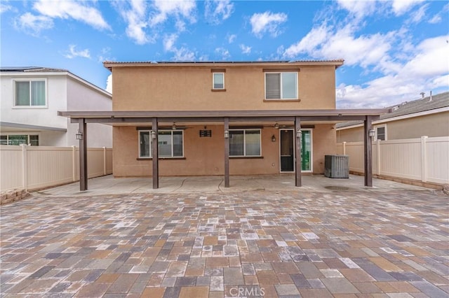 rear view of house featuring a patio and central AC unit