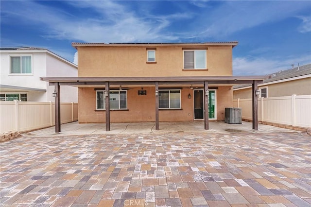 rear view of house featuring cooling unit and a patio