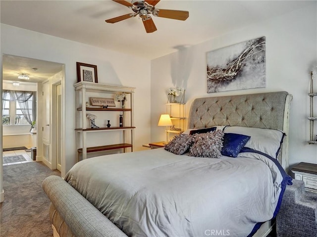 bedroom featuring ceiling fan and carpet