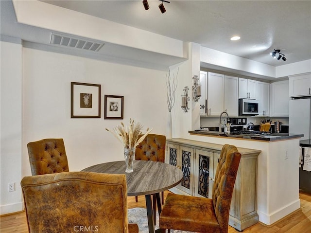 dining space featuring light hardwood / wood-style flooring