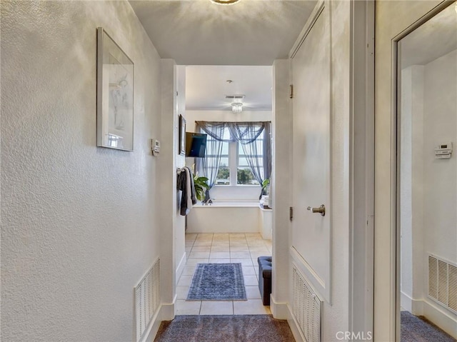 hallway with light tile patterned flooring