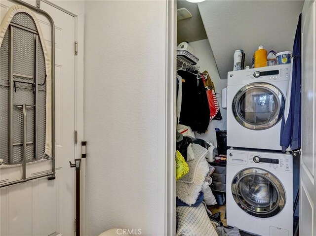 washroom with stacked washer and dryer