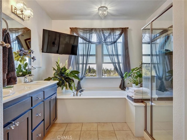 bathroom featuring tile patterned floors, vanity, an inviting chandelier, and plus walk in shower