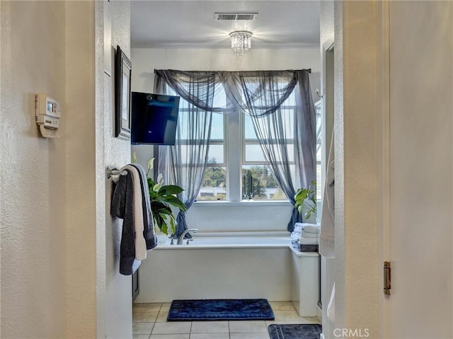 bathroom with tile patterned floors and a bathing tub