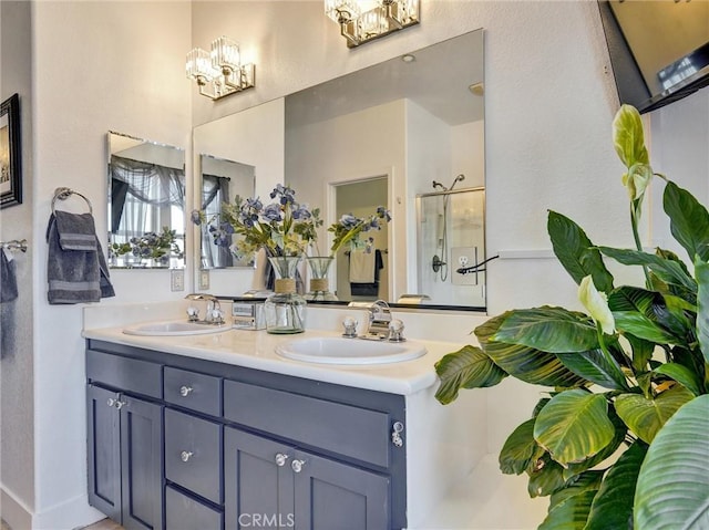 bathroom featuring vanity, a chandelier, and an enclosed shower