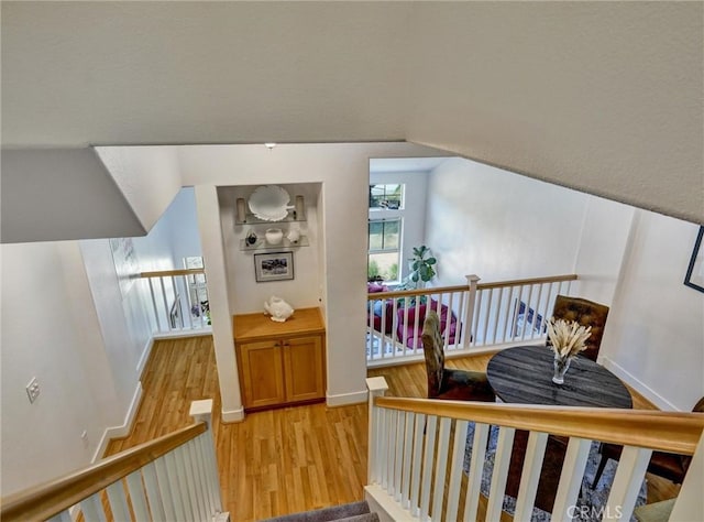 bonus room featuring light hardwood / wood-style flooring and lofted ceiling