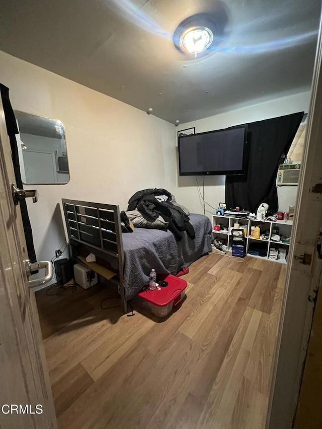 bedroom with hardwood / wood-style floors