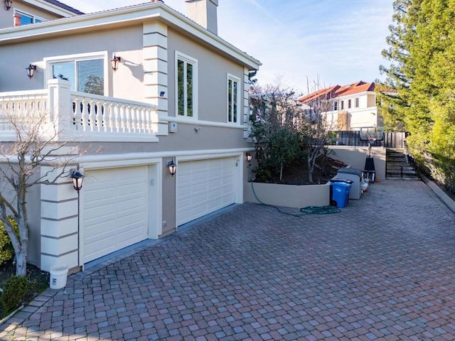 view of side of home featuring a garage