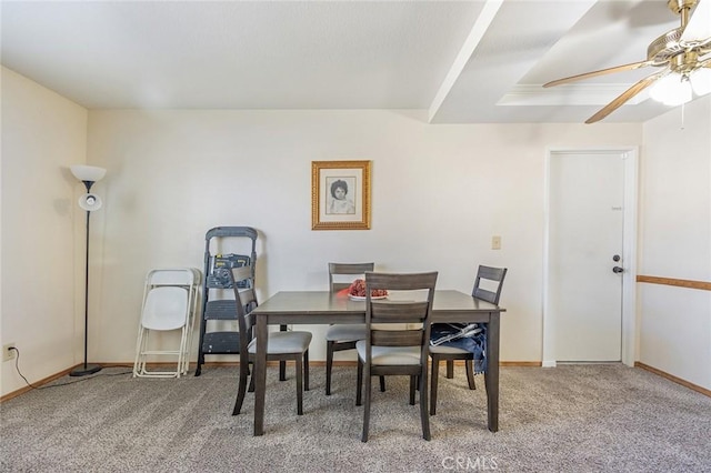 carpeted dining room featuring ceiling fan