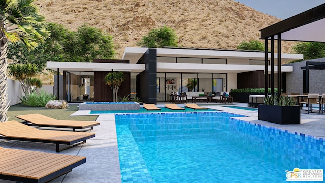 view of swimming pool with a mountain view, a patio area, and outdoor lounge area