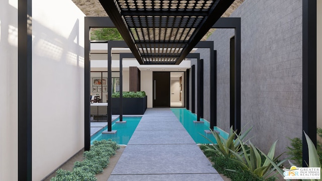 entrance to property featuring a pergola and a patio area