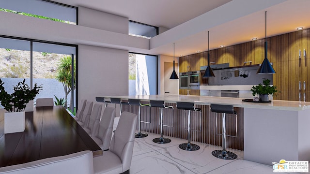 kitchen with wall oven, stainless steel oven, a kitchen bar, and wood walls