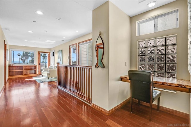 hallway with hardwood / wood-style floors