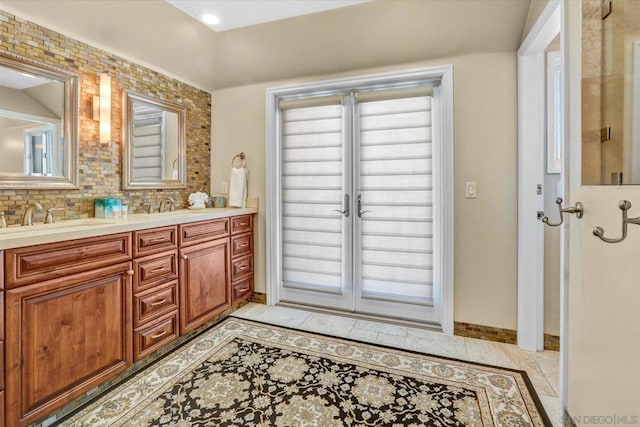 bathroom featuring vanity, decorative backsplash, and tile patterned flooring